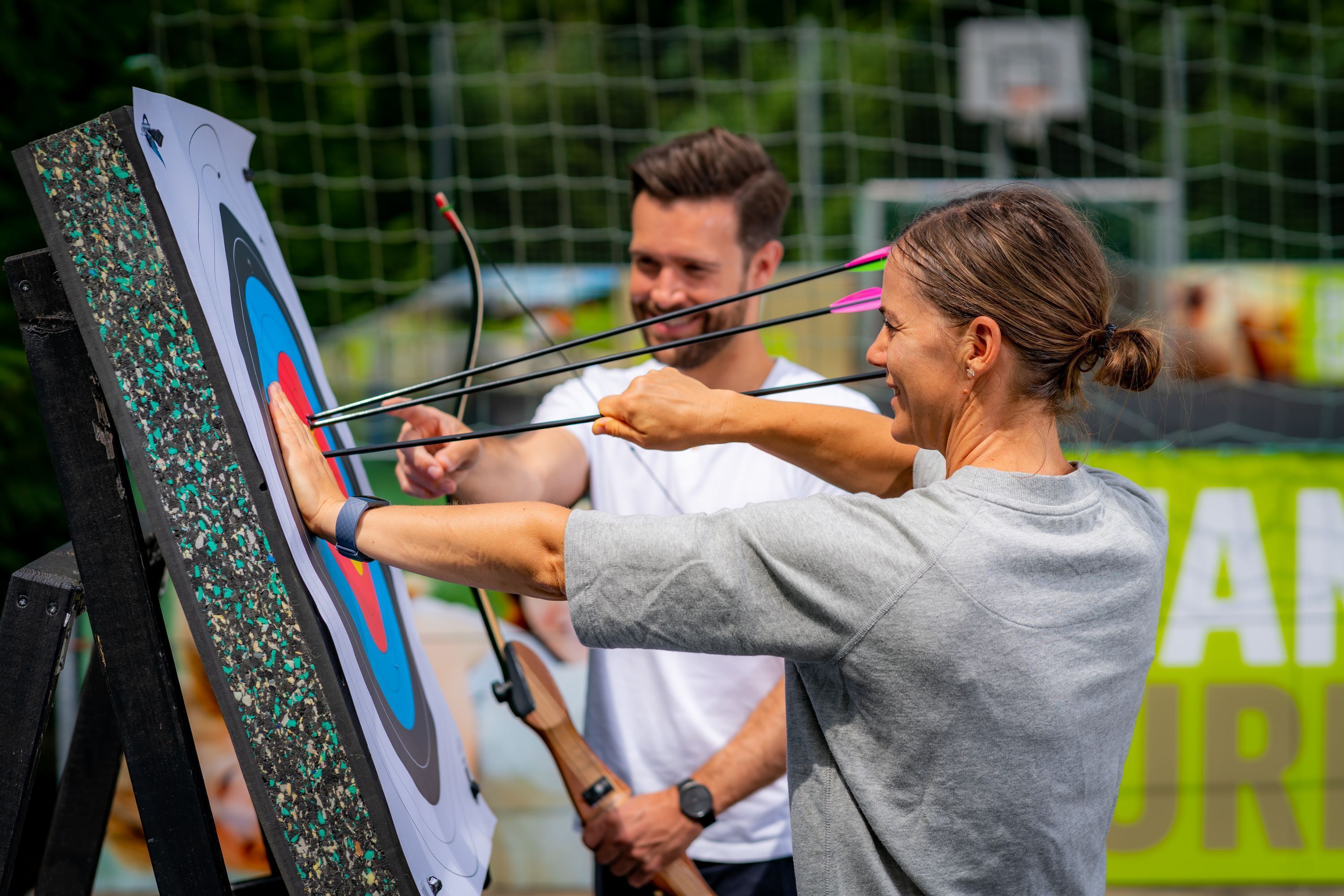 A person aiming an arrow at a target.
