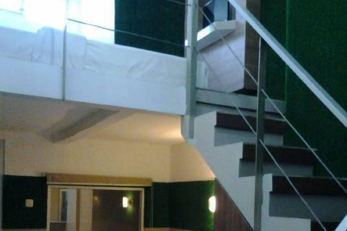 A bunk bed room with a staircase leading to an upper bunk.