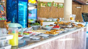 A buffet with various food items, a blue refrigerator, and a chalkboard menu. - Bahar Hotel (+12 Adult ) (Fethiye)