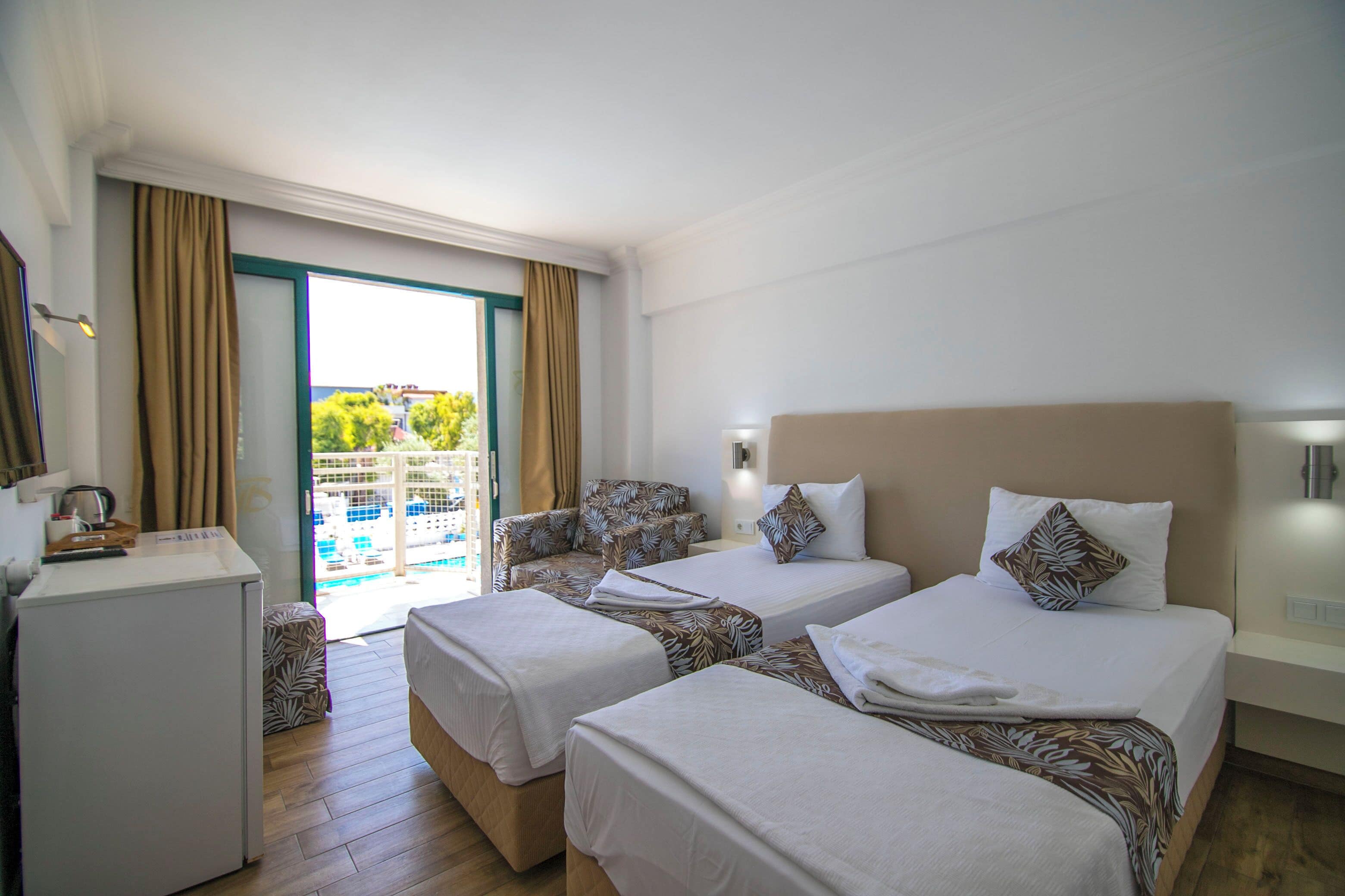 standard double or twin room, pool view | minibar, in-room safe, iron/ironing board, free wifi