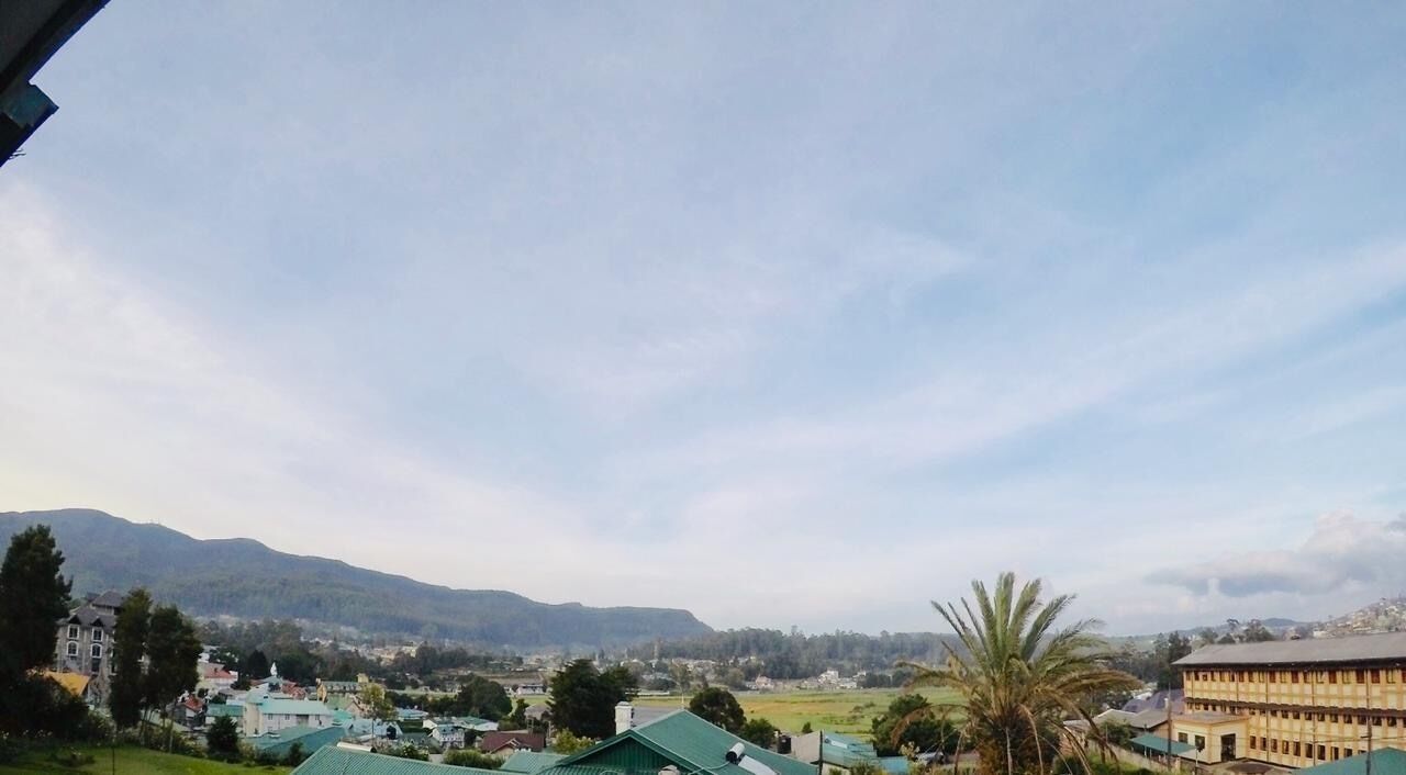 A town with buildings and a mountain in the background.