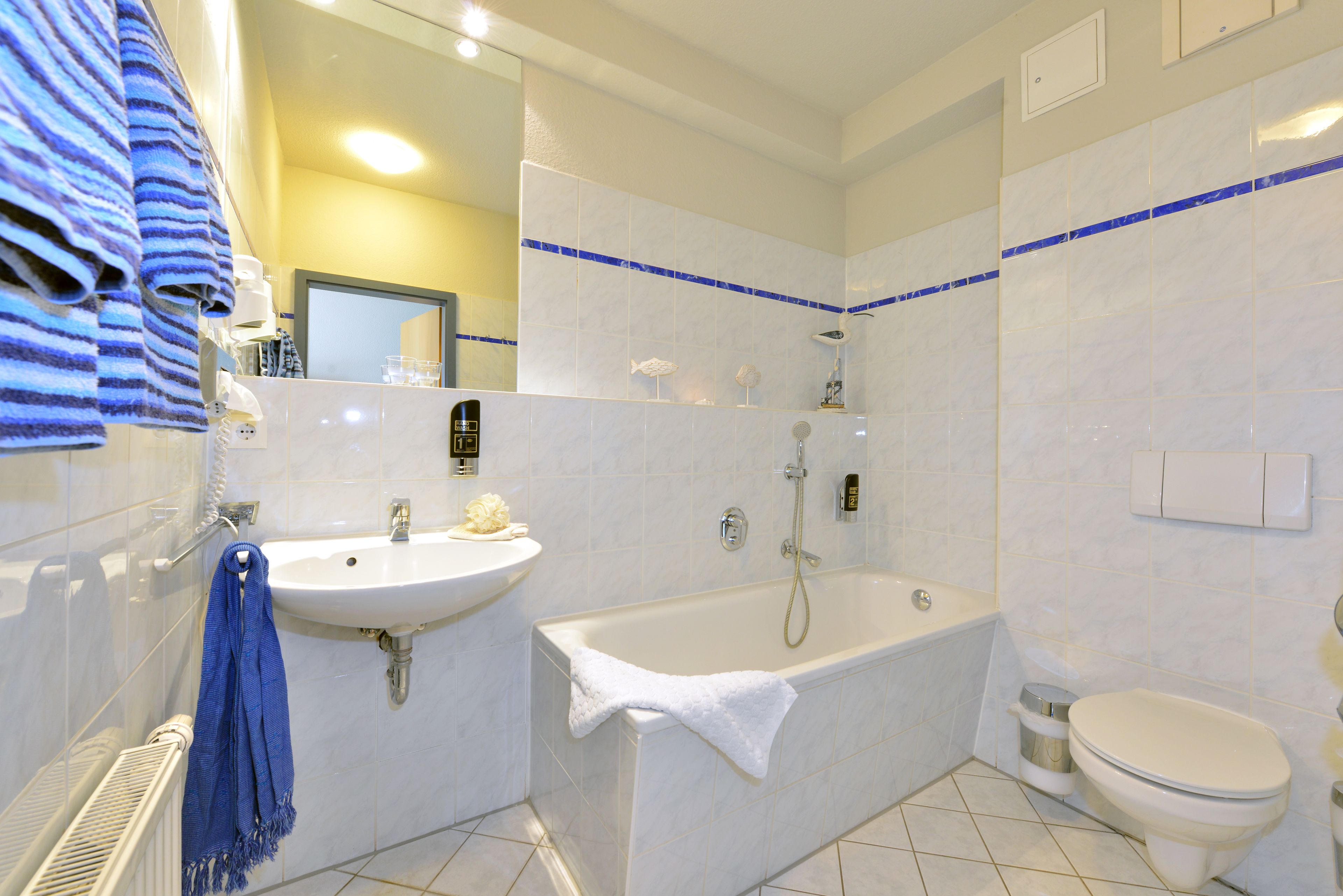 A bathroom with a bathtub, sink, and toilet.