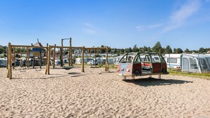 A sandy beach with a children's playground and a vintage car. - First Camp Sunne (Sunne)