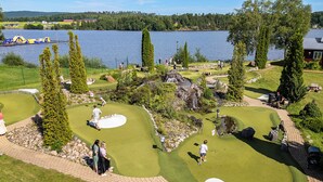 A golf course with a lake view, sand bunkers, and a pond. - First Camp Sunne (Sunne)