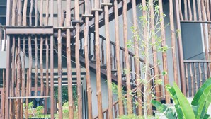 A multi-story building with a unique wooden facade and a central staircase. - The Acacia Retreat (Bentong)