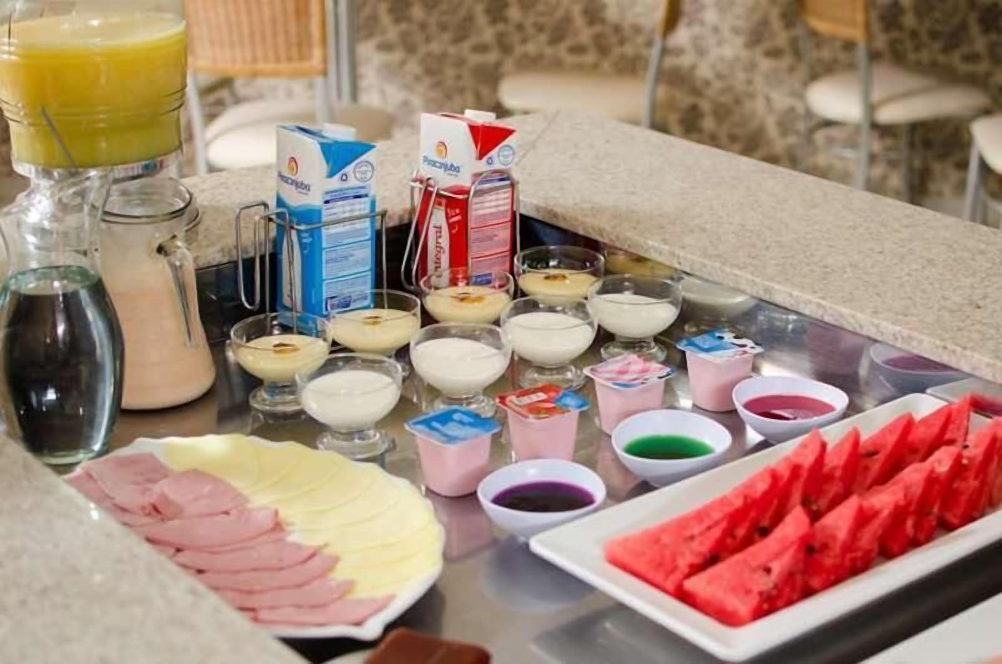 A breakfast buffet with various food items and beverages.