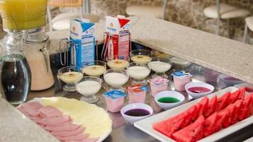A breakfast buffet with various food items and beverages.