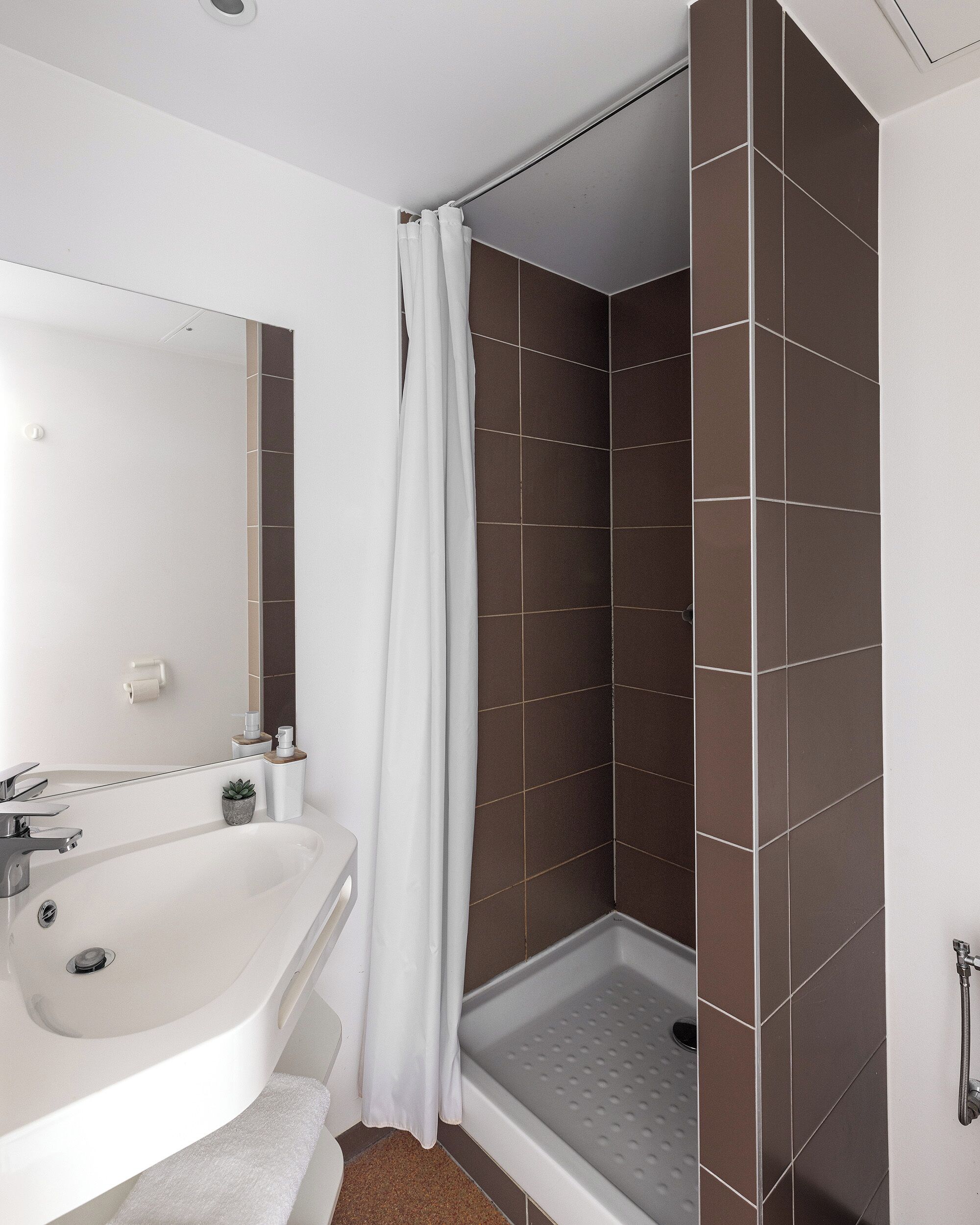 A bathroom with a bathtub, a shower, and a sink.