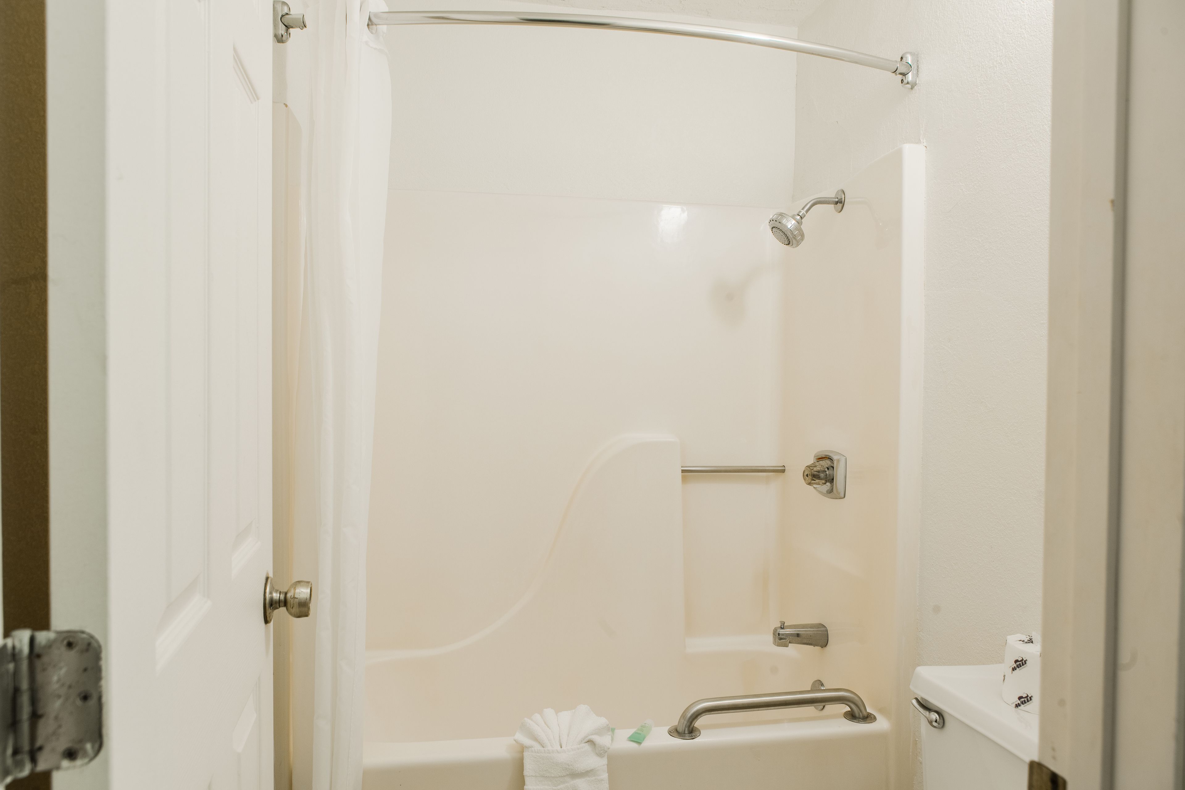 A bathroom with a bathtub, a toilet, and a sink.