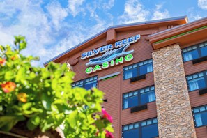 The exterior of the Silver Reef Casino with a prominent sign, multiple windows, and a stone pillar. - Silver Reef Casino Resort (Ferndale)