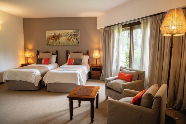 A hotel room with two beds, a sofa, a coffee table, and a painting on the wall. - La Posta del Pilar Hotel & Spa - Adults Only (Fátima)