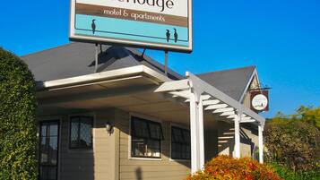 Enjoy a welcoming stay at Riverlodge, featuring a covered porch and motel-style accommodations.