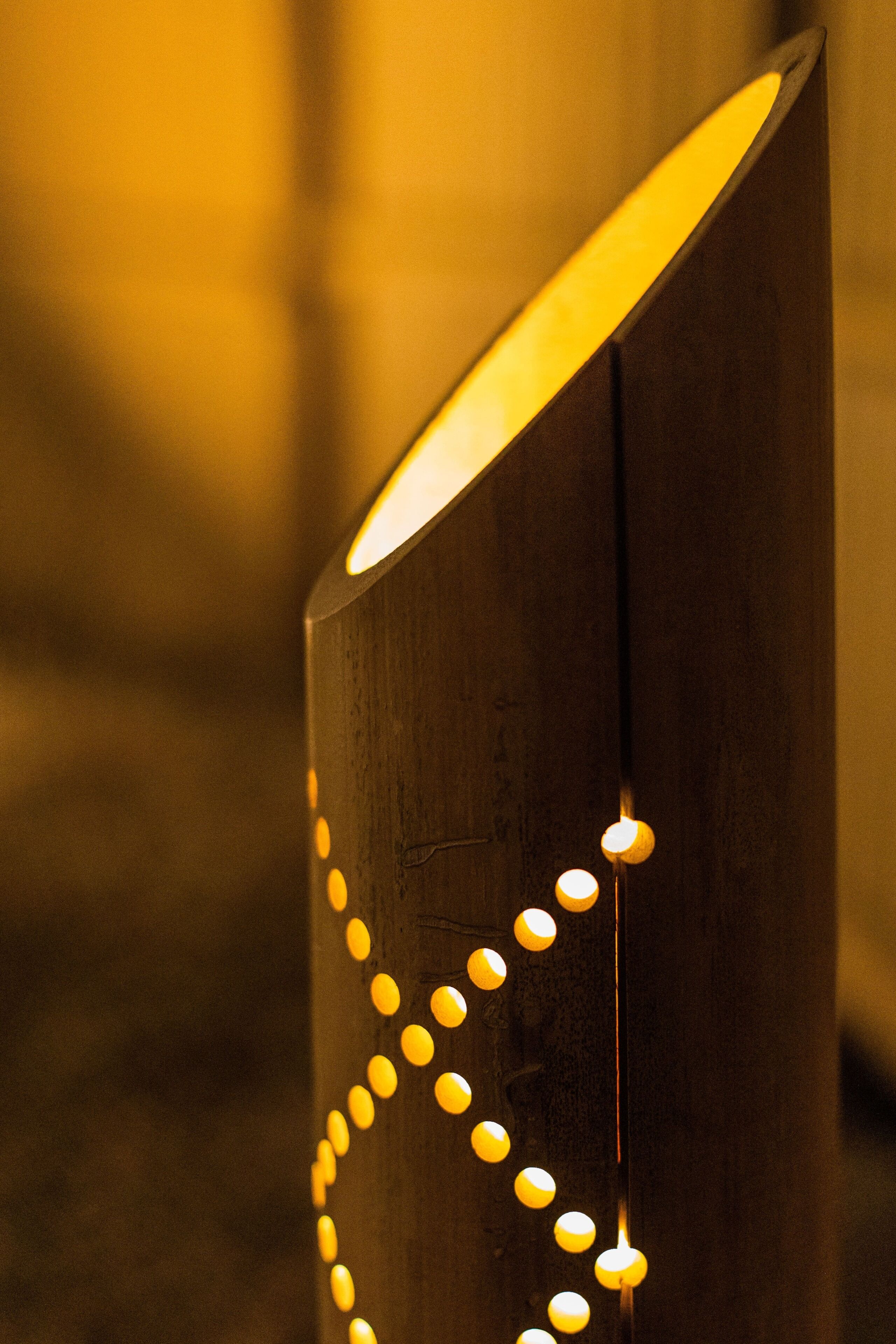 A wooden structure with a series of lights arranged in a pattern.