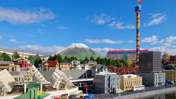 A model town with a prominent tower, a mountain in the background, and a variety of buildings.
