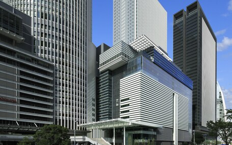 A modern high-rise building with a glass facade and a distinctive angular design.