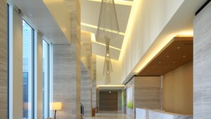 A modern lobby with a high ceiling, a unique hanging light fixture, and a reception desk. - Nagoya JR Gate Tower Hotel (Nagoya)
