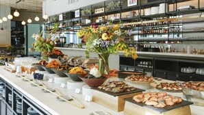 A buffet setup with various food items and a floral centerpiece. - Nagoya JR Gate Tower Hotel (Nagoya)