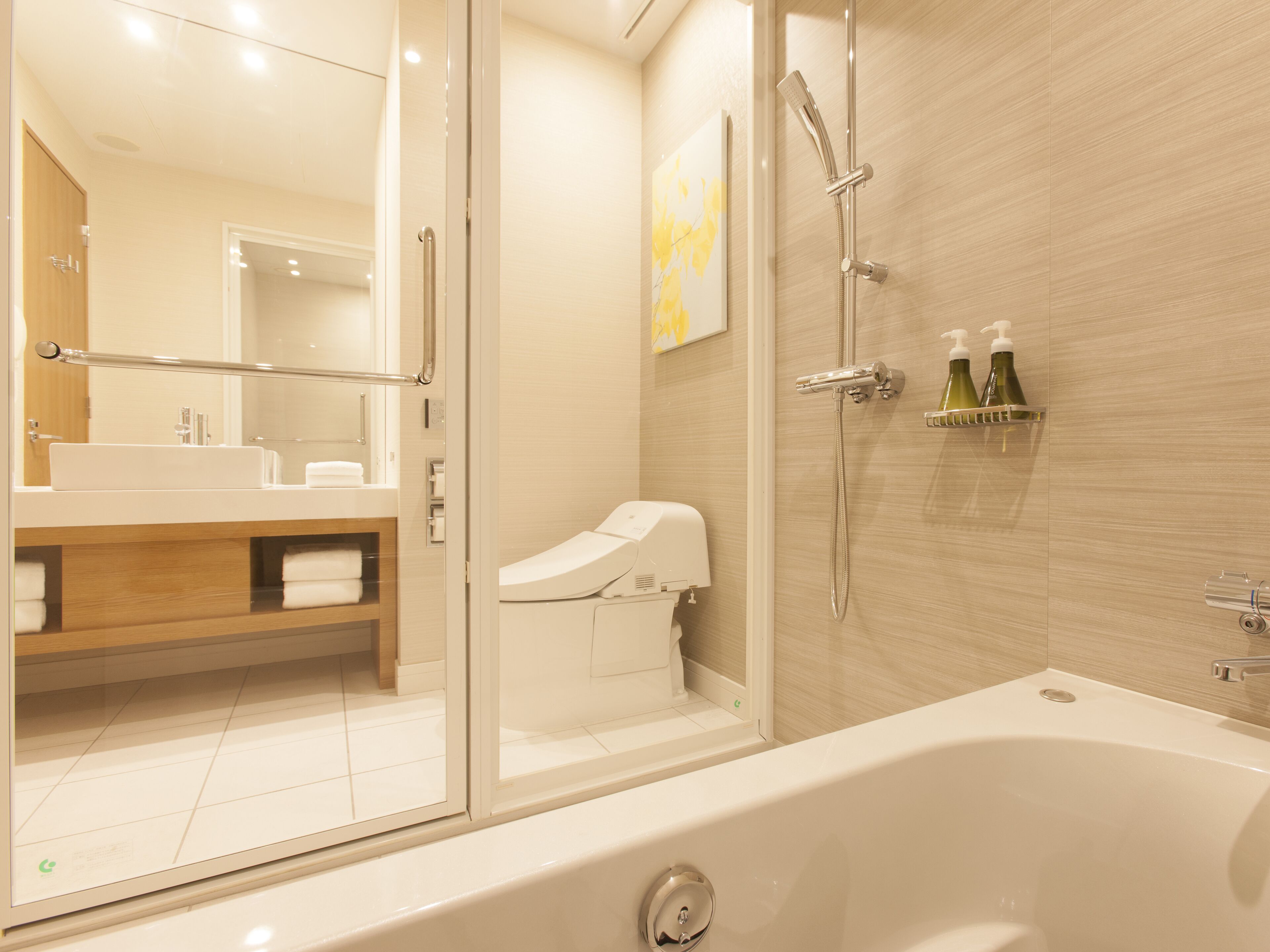 A modern bathroom with a glass-enclosed shower, a large bathtub, and a wooden vanity with a mirror.