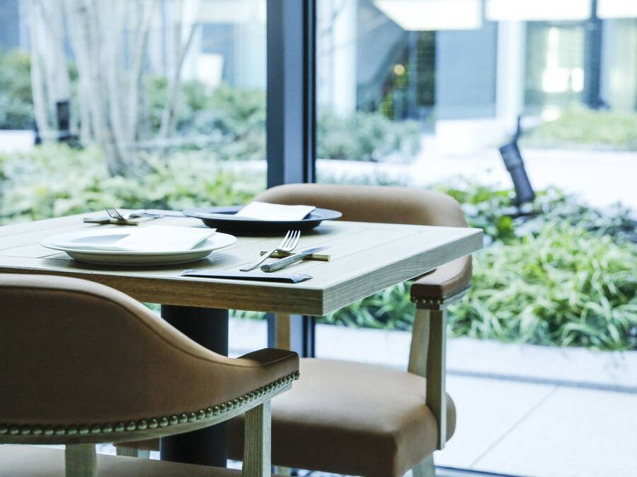A dining table set with plates, cutlery, and a napkin.