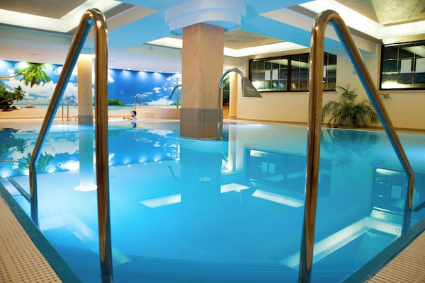 Indoor pool, open 8:00 AM to 9:00 PM, pool loungers, lifeguards on site