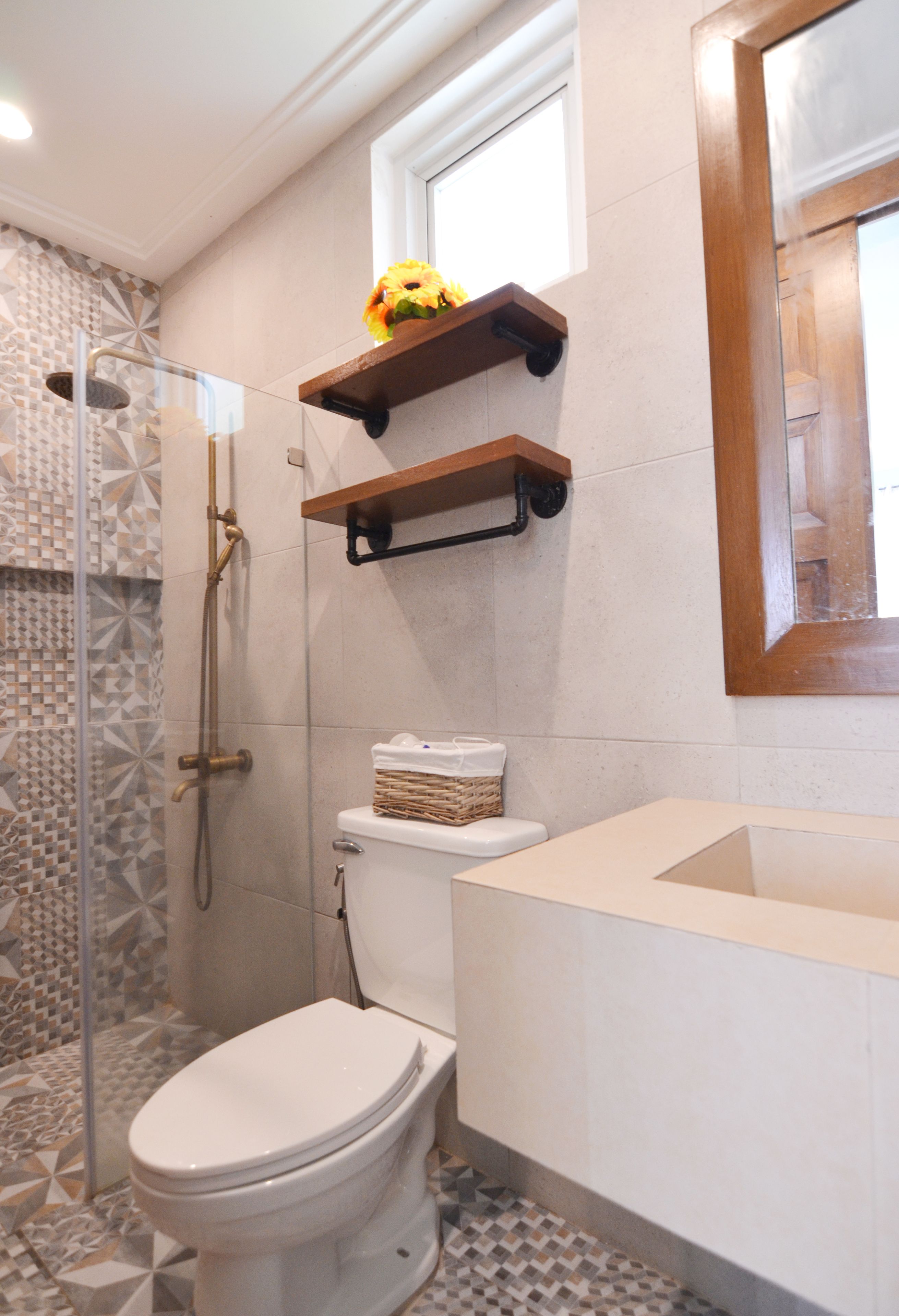 A bathroom with a shower, toilet, and a sink.
