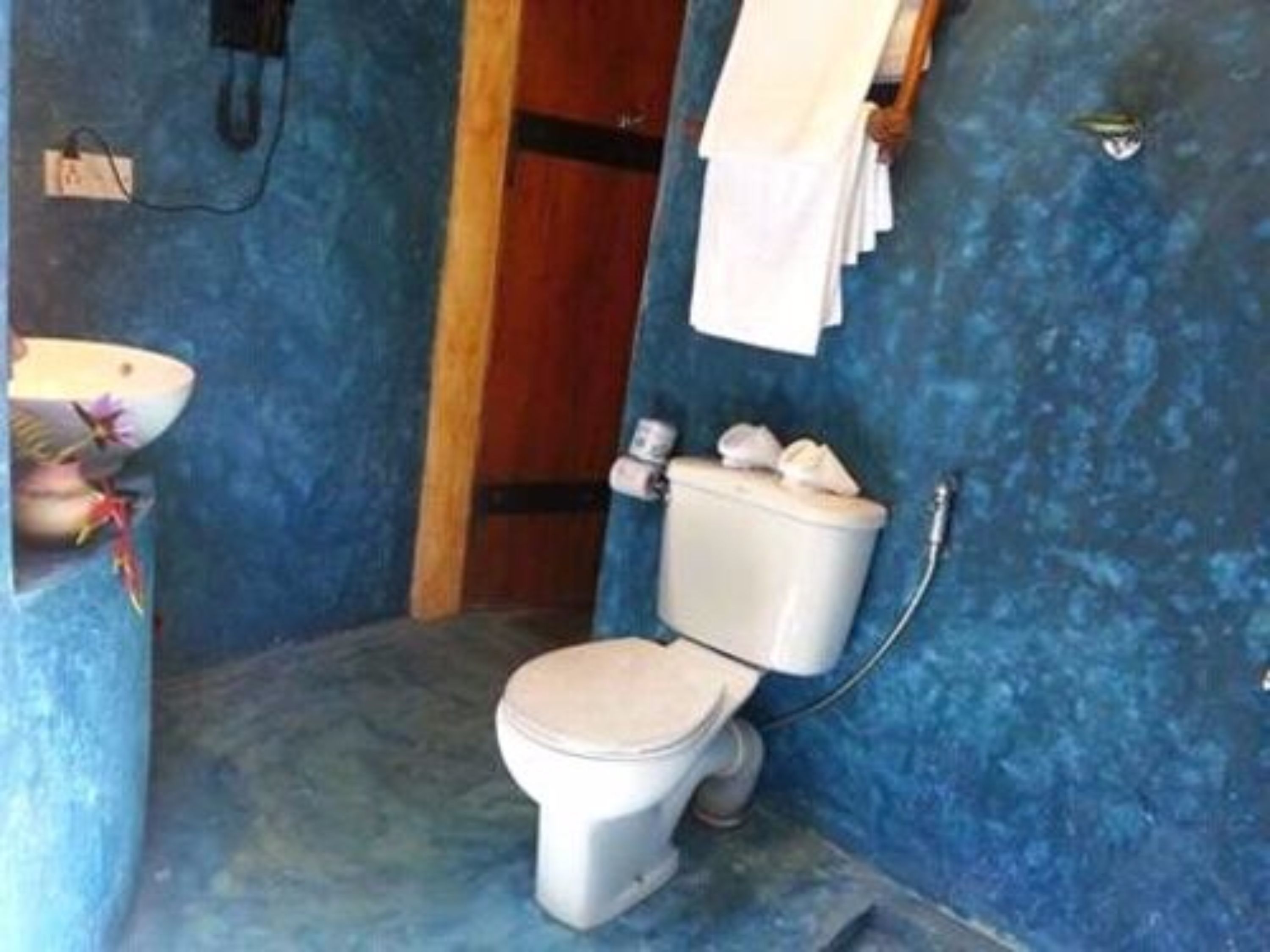 A bathroom with a toilet, a sink, and a shower.