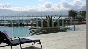 A lounge area with a view of a marina and beach. - The View (Cape Town)