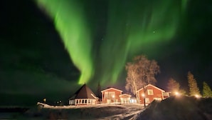 A building with a snow-covered ground and a visible roofline. - Hotell Kraja (Arjeplog)