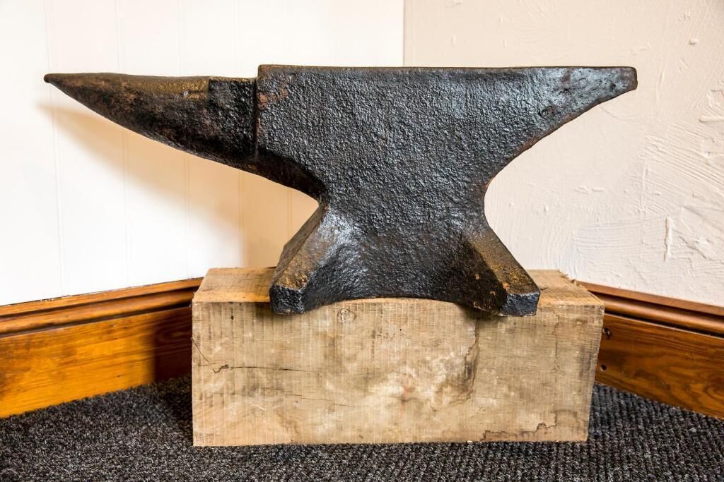An anvil on a wooden block.