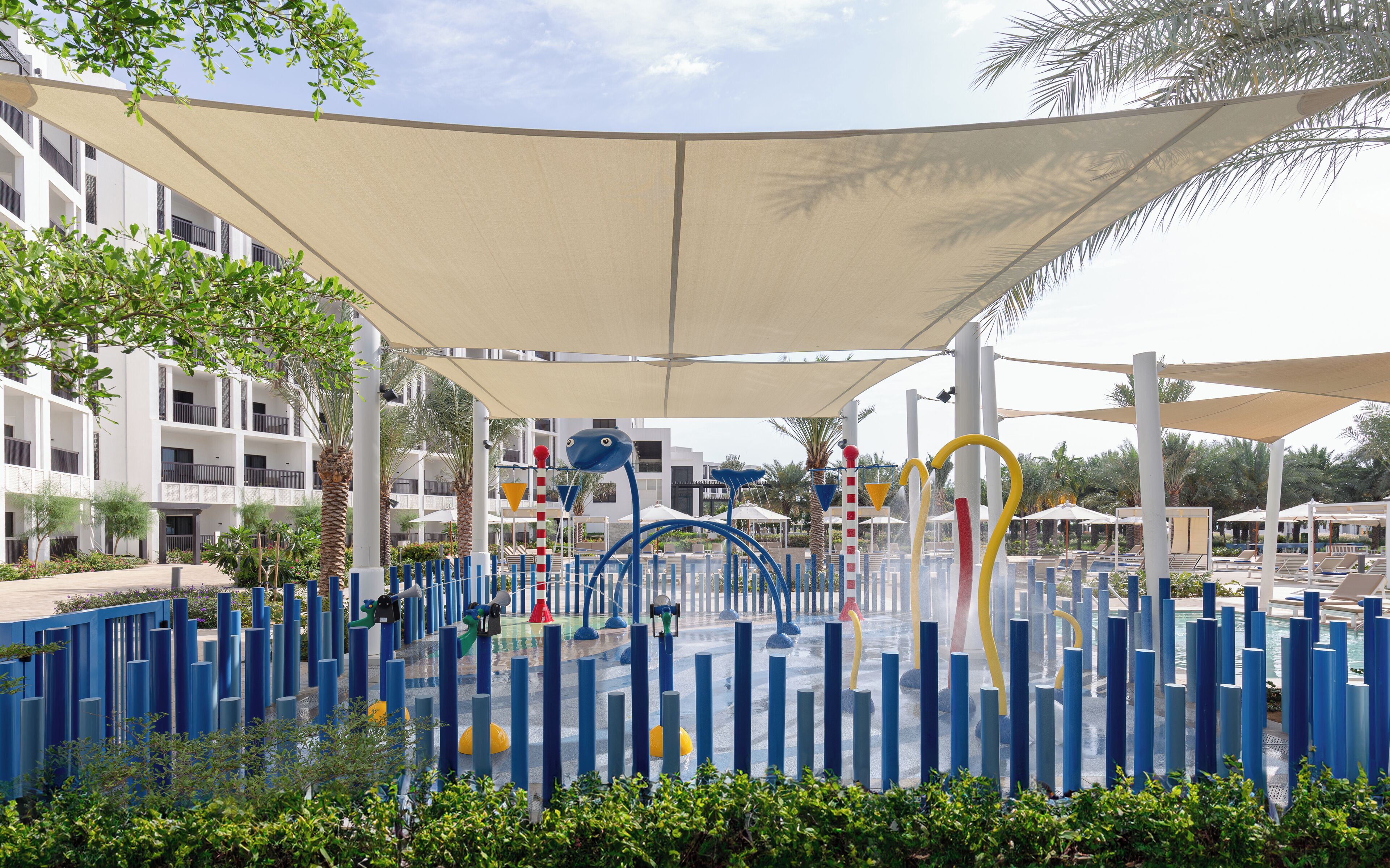 A water play area with colorful structures and a covered seating area.