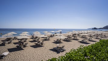 Private beach, white sand, sun loungers, beach umbrellas