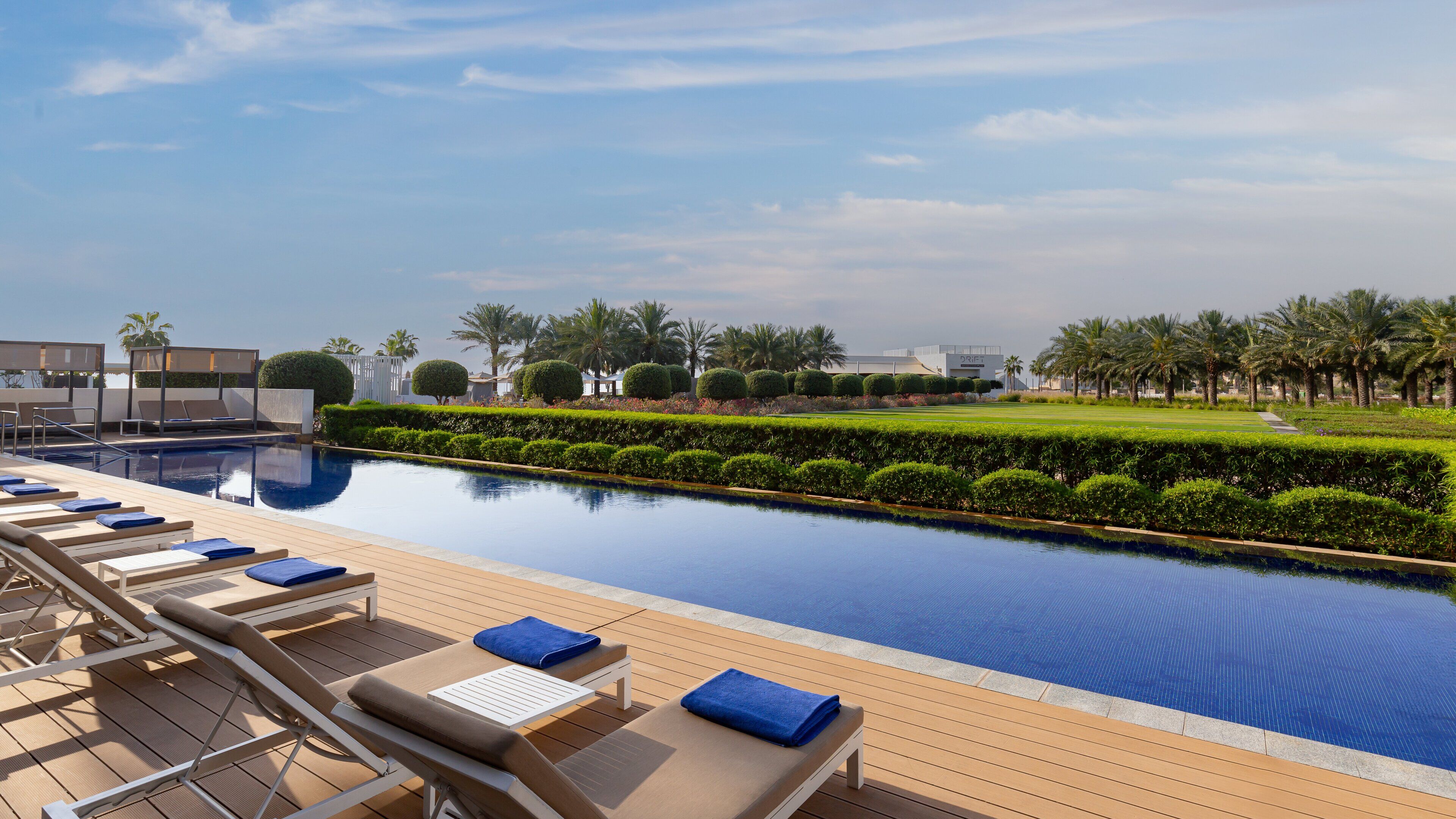 A poolside area with lounge chairs and a clear view of the pool.