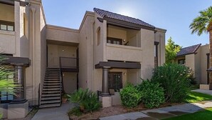 A modern multi-story residential building with a flat roof, a central staircase, and a small balcony. - Exclusively Yours By Signature Vacation Rentals (Scottsdale)