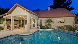 A residential property with a swimming pool, covered patio, and a house with a tiled roof. - Velvet Dream By Signature Vacation Rentals (Tempe)
