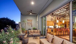 Un patio al aire libre con sofá, sillas y una zona de comedor.