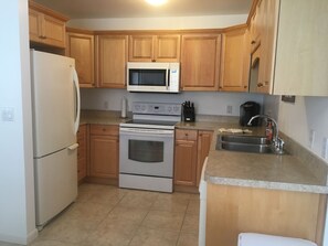 Hercules 2 Bedroom 2 Bath | Private kitchen | Full-sized fridge, microwave, oven, stovetop - Hercules Weekly Vacation Rental (Fort Myers Beach)