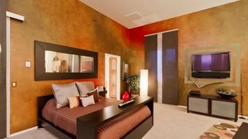A modern bedroom with a bed, bedside table, TV, and a mirror.