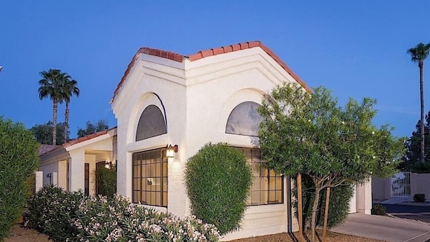 A modern house with a white exterior, red roof, and large windows. - Take It Easy By Signature Vacation Rentals (Tempe)