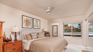 A bedroom with a bed, bedside tables, lamps, and artwork on the walls. - Sweet Escape By Signature Vacation Rentals (Scottsdale)