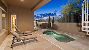 A pool area with lounge chairs and a hot tub. - Desert Rose By Signature Vacation Rentals (Scottsdale)