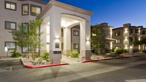 A modern building with a numbered entrance, well-lit exterior, and landscaped surroundings.