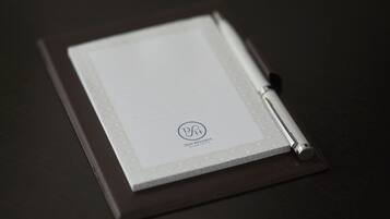 A closed notebook with a pen on top, featuring a logo and text indicating it is from DSH Resorts.