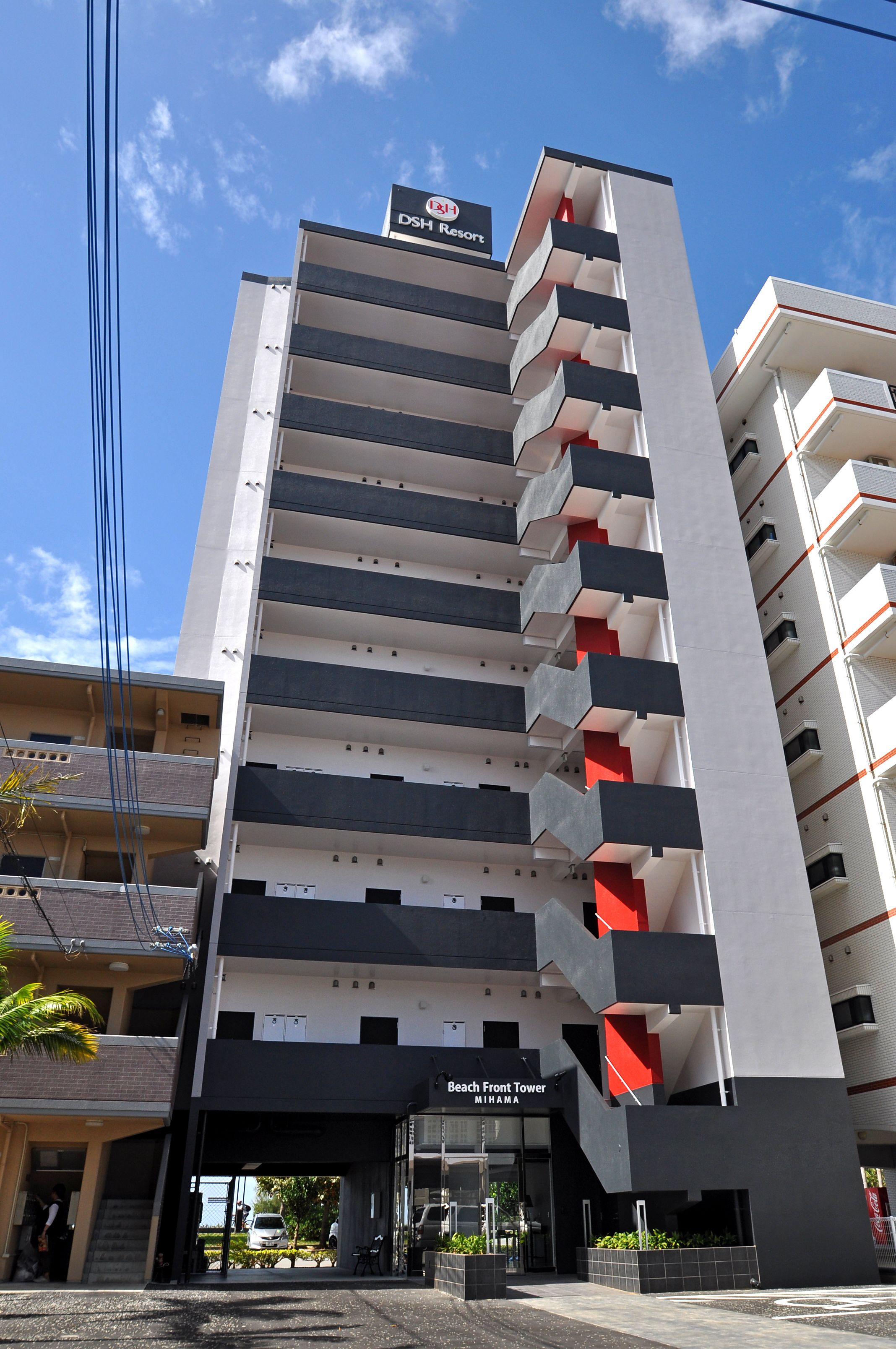 A modern hotel with a prominent sign for DSH Resort. It features a multi-story structure with balconies and a Beach Front Tower.