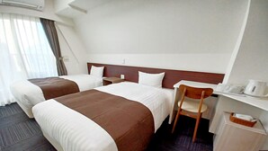 A hotel room with two beds, a desk, a chair, and a coffee maker. - Akasaka Urban Hotel (Tokyo)