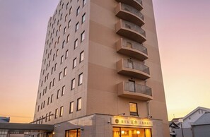 A tall building with multiple balconies and a sign indicating a restaurant. - HOTEL KAN-RAKU Mishima Main Street (Mishima)