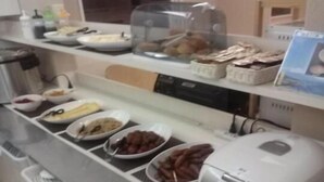 A buffet counter with various food items and a coffee machine. - Hotel Select Inn Numazu (Numazu)