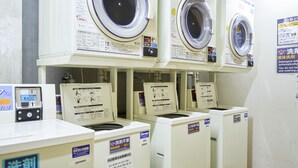 A row of stacked washing machines in a commercial setting. - Hotel Select Inn Numazu (Numazu)
