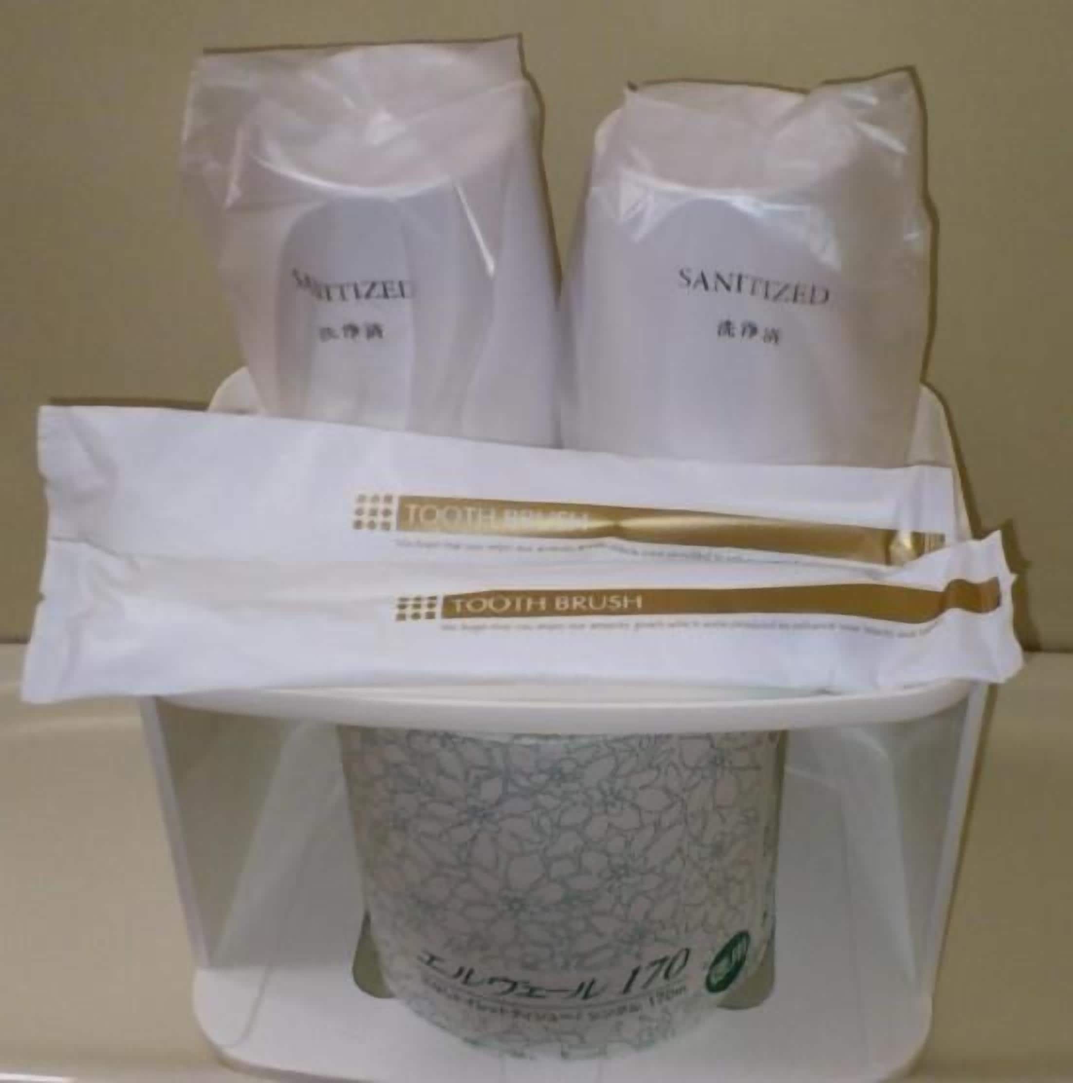 A dental hygiene kit with a toothbrush, toothpaste, and a mouthwash bottle.
