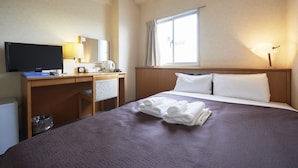 A hotel room with a bed, a desk with a computer, a television, and a window with curtains. - Hotel Select Inn Nagoya Iwakura Ekimae (Iwakura)