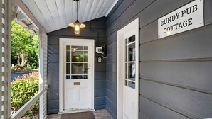 A wooden exterior with a sign reading "Bundy Pub Cottage." - Bundanoon Hotel (Bundanoon)